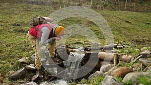 close-up male hands draw water from a mountain river. man drinking water