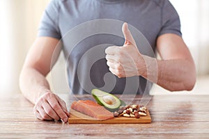 Close up of male hands with food rich in protein