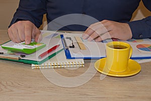 Close up of male hands on her calculator`s keyboard. Concept of accountant`s work. Businessman using a calculator to calculate t