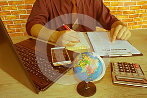 Close up of male hands on her calculator`s keyboard. The second hand in on the touchpad. Concept of accountant`s work