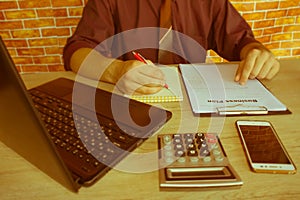 Close up of male hands on her calculator`s keyboard. The second hand in on the touchpad. Concept of accountant`s work