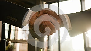 Close up male hands multiethnic Caucasian and African business people men diverse businessmen shaking successful