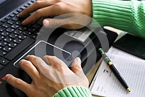 Close-up of male hands over black keyboard of laptop during typing