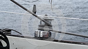 Close up of male hands pulling rope of sailboat, Yachtsman hands dealing with yacht ropes on halyard winch, Rope hauling