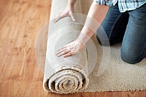 Close up of male hands rolling carpet