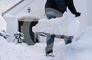 Close up of male hands shoveling snow