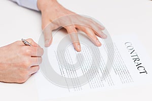 Close up of male hands signing contract document