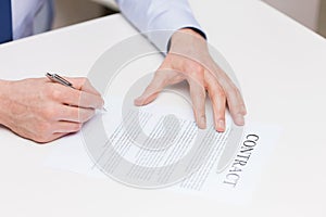 Close up of male hands signing contract document