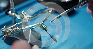 Close-up of a male hands soldering a video transmitter chip from an FPV drone