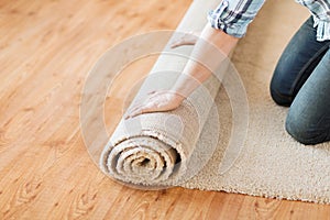 Close up of male hands unrolling carpet