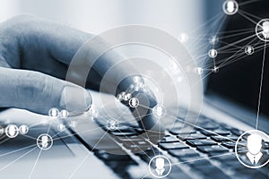 Close up of male hands using laptop on desk with glowing video conference hologram and polygonal connections on blurry background