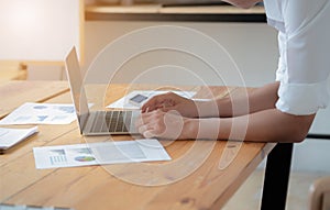 Close-up of male hands using laptop, man`s hands typing on laptop keyboard, side view of businessman using computer in meeting