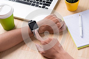 Close up of a male hands using a modern smart watch.
