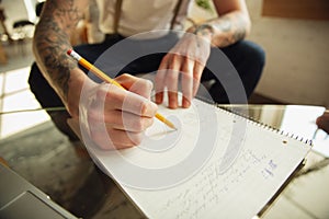 Close up of male hands writing on an empty paper, education and business concept