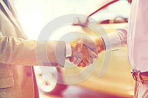 Close up of male handshake in auto show or salon