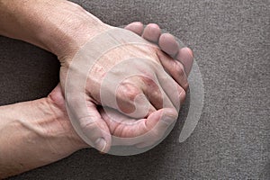 Close-up of male masculine young worker hands with rough skin and short fingernails resting on flat copy space background, top