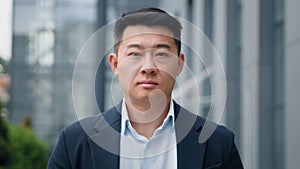 Close up male portrait in city outdoors Asian middle-aged 40s adult success representative businessman investor