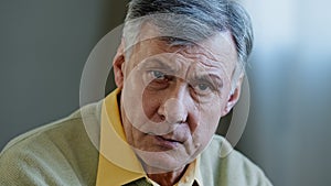 Close-up male portrait webcam view at home Caucasian angry mad face elderly serious old man looking at camera, shaking
