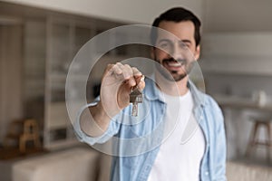 Close up of male renter show keys to new home