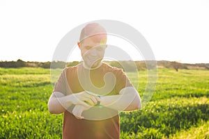 Close-up of Male runner jogging outside looking at his wearable fitness tracker outside.