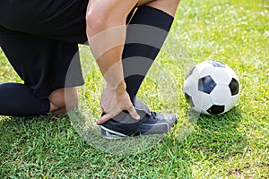 Male Soccer Player Suffering From Ankle Injury photo