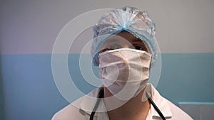 Close up of a male surgeon`s face wearing surgical mask