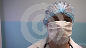 Close up of a male surgeon`s face wearing surgical mask