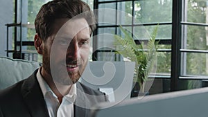 Close-up male worker leader Caucasian businessman bearded mature adult 40s manager looking at window smiling working