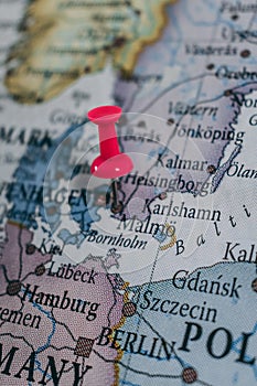 Close up of MalmÃ¶ pin pointed on the world map with a pink pushpin