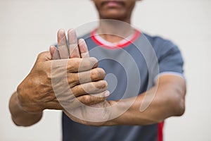 Close-up of a man bending his hand due to nerve endings