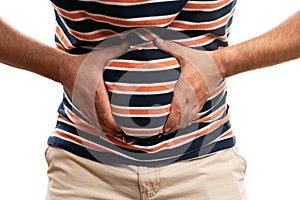 Close-up of man with bloated stomach touching as abdominal pain