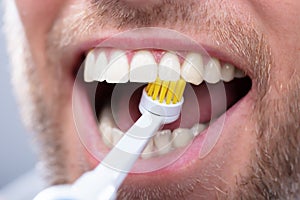 Close-up Of A Man Brushing Teeth photo