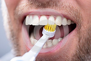Close-up Of A Man Brushing Teeth