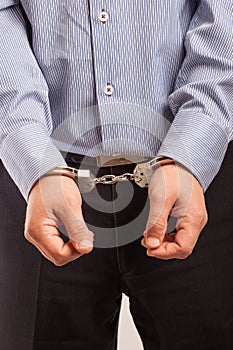 Close up of a man, businessman in handcuffs arrested