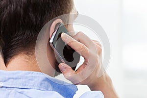 Close up of man calling on smartphone at home