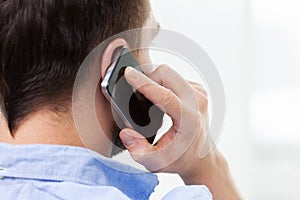 Close up of man calling on smartphone at home photo