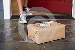 Close Up Of Man Collecting Parcel Delivery Outside Door