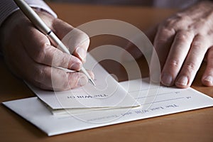 Close Up Of Man Completing Last Will And Testament