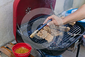 Close Up Of man Cooking Food On BBQ