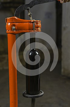 close-up of a man corking a bottle of wine at a winery .