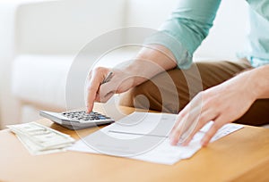 Close up of man counting money and making notes