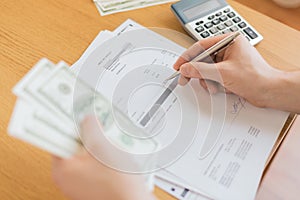 Close up of man counting money and making notes