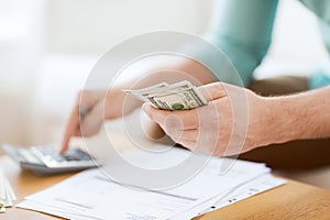 Close up of man counting money and making notes