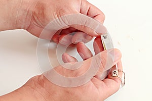 Close up of man cutting fingernails using nail clipper