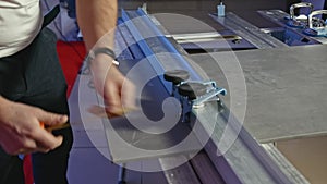 Close-up of man cutting tile products on machine. Creative. Machine with fastening for cutting tiles. Carpenter with