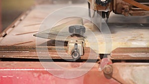 Close-up of a man cutting tiles and granite with an electric circular saw and applying water to it