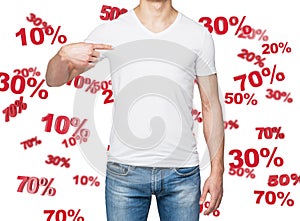 Close up of the man in denims and a white t-shirt pointing out to the chest. The concept of the discount and sale. 10% 20% 30%