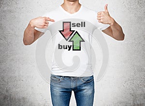 Close up of the man in denims and a white t-shirt pointing out to the chest with drawn arrows: buy and sell. The concept of the ca