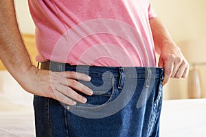 Close Up Of Man On Diet Losing Weight From Waist