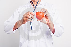 Close up Man doctor with stethoscope he is holding red heart on hand